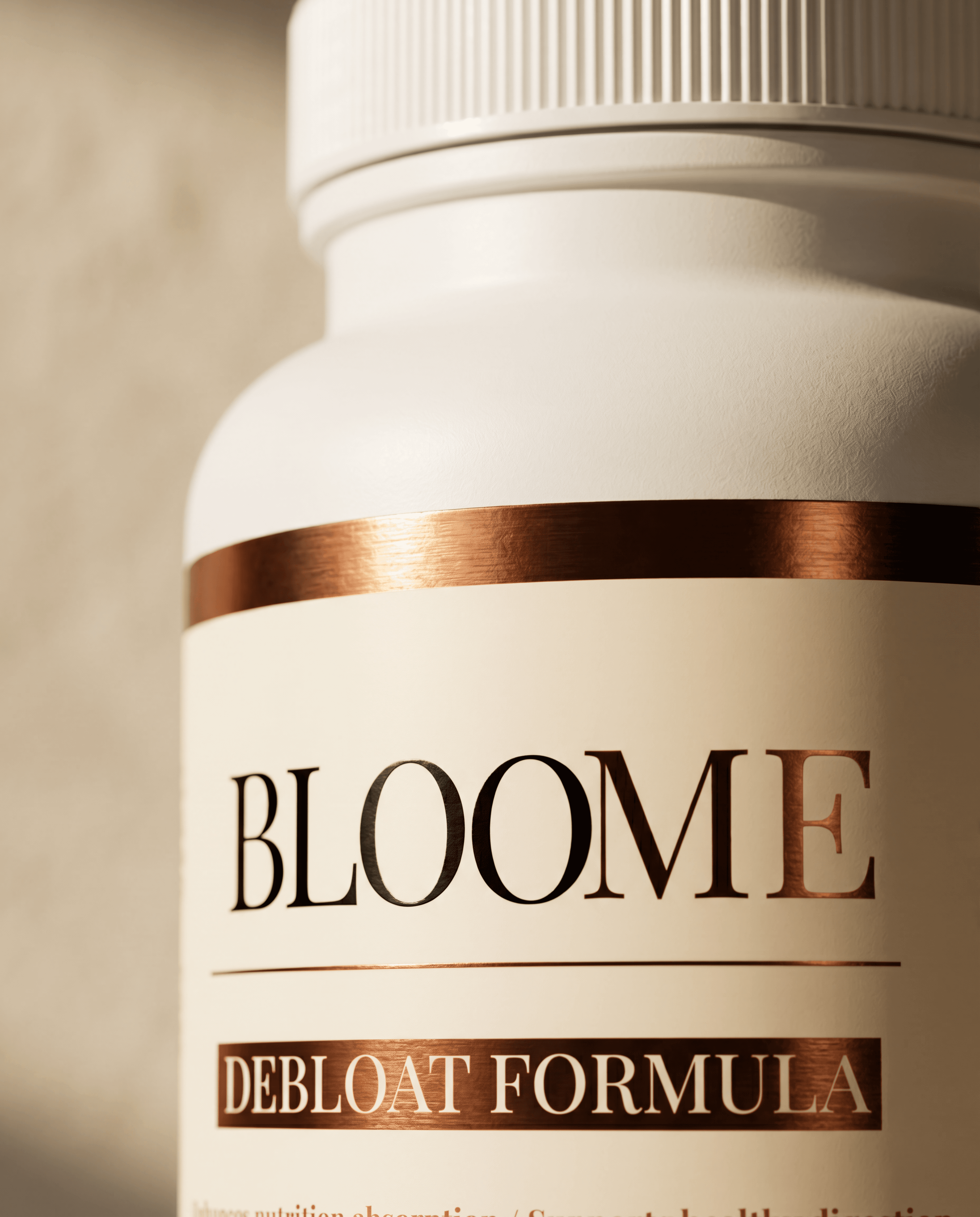 Close-up detail of Bloome Debloat Formula label and rose-gold foil
