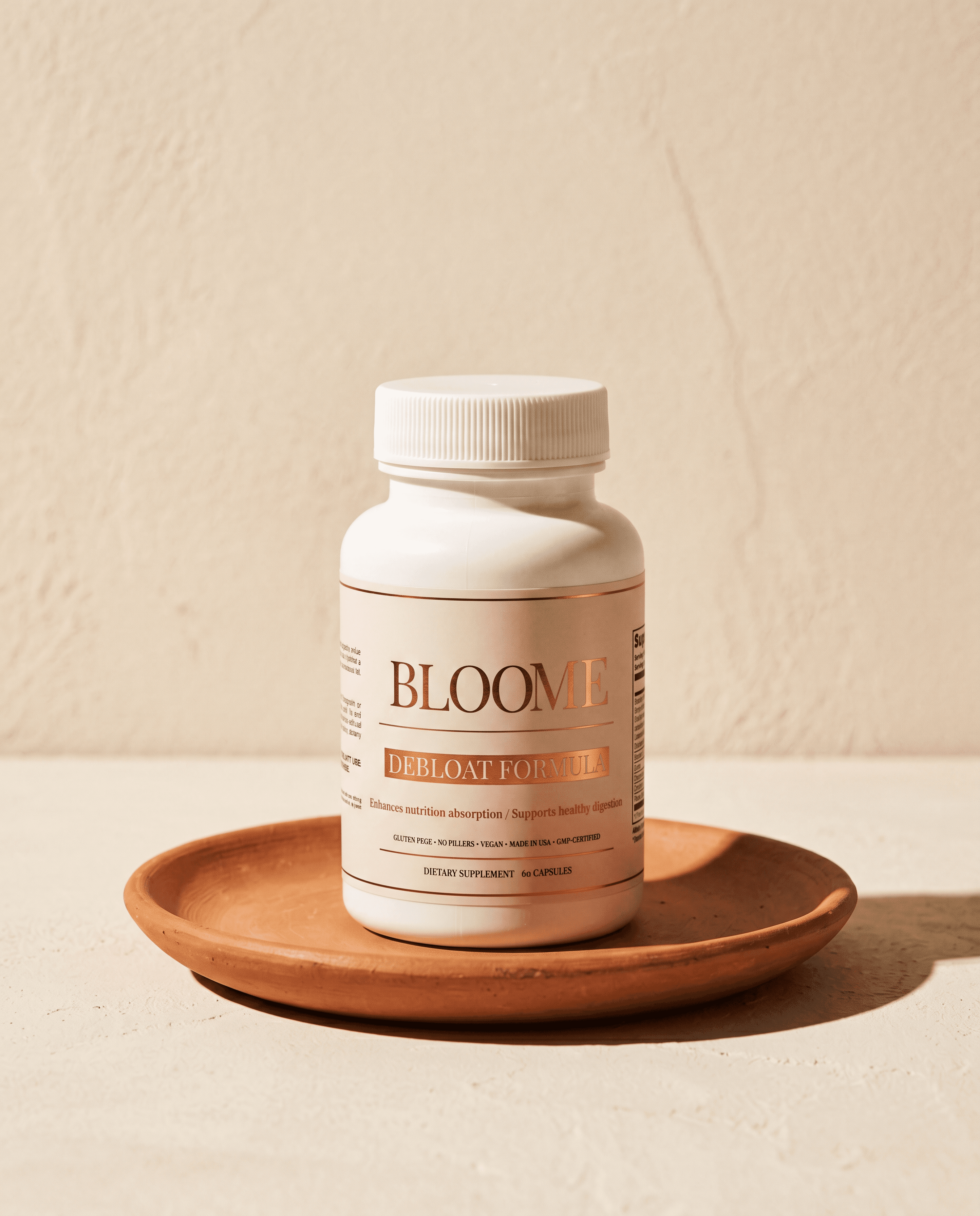 Bloome Debloat Formula on hand-thrown terracotta saucer